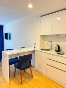 a kitchen with a table and a chair at EVIS LTD apartments Batumi 2 in Angisa