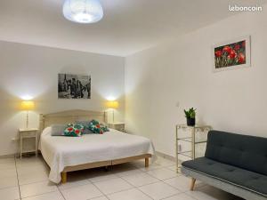 a bedroom with a bed and a couch at Kazanou in Saint-Pierre