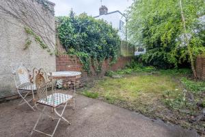 a patio with two chairs and a table at Large House, Garden, 3 Bedrooms in Bristol