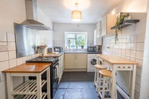 a kitchen with a sink and a stove top oven at Large House, Garden, 3 Bedrooms in Bristol
