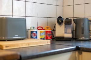 a kitchen counter with a laptop sitting on a counter top at Large House, Garden, 3 Bedrooms in Bristol