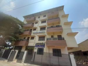 a tall building with a fence in front of it at Sanvika Hotels & Service Apartments in Coimbatore