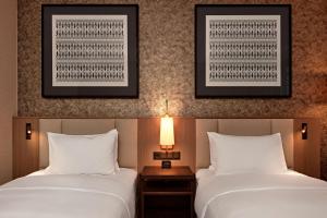 Postel nebo postele na pokoji v ubytování Hilton Vienna Park
