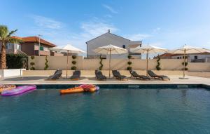 a swimming pool with several inflatables in the water at Amazing Home In Biograd Na Moru in Biograd na Moru