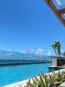 a swimming pool with a view of the ocean at Estúdio luxuoso Vista Mar, Art Studio Open Space in Salvador