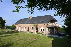 a large brick building with windows and a porch at Domaine des Agapanthes Chambres d'hôtes et Spa in Épreville