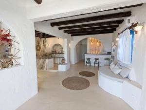 ein Wohnzimmer mit weißen Wänden und einem weißen Sofa in der Unterkunft Camares in Alopronia
