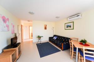 a living room with a couch and a table at Apartments Ivan in Zadar