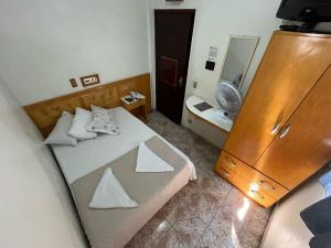 a small bedroom with a bed and a mirror at Hotel Mooca in São Paulo +107 photos