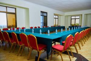 a long blue table and chairs in a room at KiliCrane Lodge Arusha in Arusha