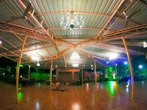 a large room with a chandelier and a dance floor at Whispering Woods Resort in Lonavala