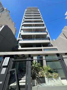 a tall building with plants on the side of it at Gorriti Apartment in Lomas de Zamora +2 photos