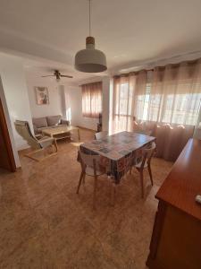 a living room with a table and a couch at 3ºB Escobar in Nerja