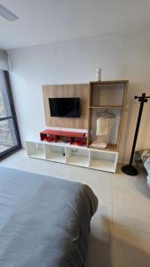 a living room with a tv and a bed at Departamento centro in Paraná