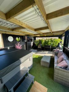 an outdoor patio with a large table and chairs at The Lodge Mountain View Log Cabin , Attymass Ballina in Boyhollagh