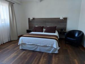 Postel nebo postele na pokoji v ubytování Conrado Hotel Osorno