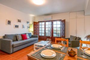 a living room with a couch and a table at CAIS APARTMENT by Stay in Alentejo in Vila Nova de Milfontes