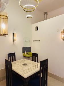 a dining room with a table and chairs at Kamaree-7BHK in Varanasi +36 photos