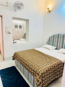 a bedroom with a bed and a mirror in it at Kamaree-7BHK in Varanasi