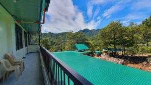 a balcony of a house with a swimming pool at Tuking Mt Inn and Restaurant in Sagada