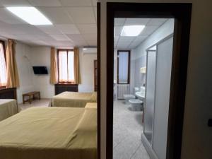 Postel nebo postele na pokoji v ubytování Hotel mariuccia