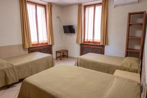 Postel nebo postele na pokoji v ubytování Hotel mariuccia