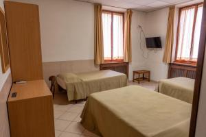 Postel nebo postele na pokoji v ubytování Hotel mariuccia