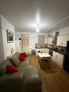 a living room with a couch and a table at Britannia Stay Stockwell - 13 min to Oxford Circus in London