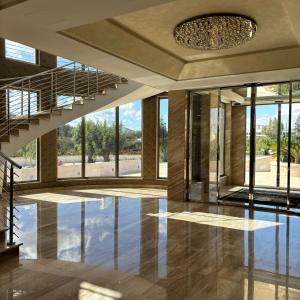 a large lobby with a staircase and glass windows at Hotel Donna Crescenza in Locorotondo