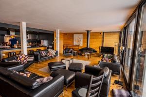 a living room with leather furniture and a fireplace at Chalet Arktic - Catered Chalet - Sleeps 14 in Tignes