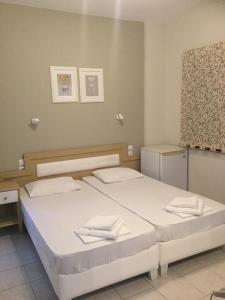 a bedroom with two beds with towels on them at IVAS Pelion in Agios Ioannis Pelio