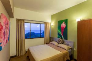 Ένα ή περισσότερα κρεβάτια σε δωμάτιο στο Sri Sayang Seaview Holiday Home +97 φωτογραφίες