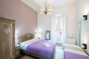 a bedroom with two beds and a chandelier at My Tiny Home Alchemy in Rome