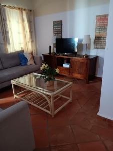 a living room with a couch and a coffee table at Casa David Duplex in Olhão