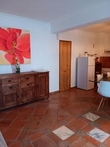 a living room with a refrigerator and a table at Casa David Duplex in Olhão +5 photos