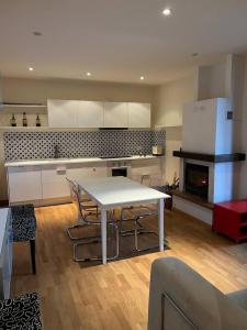a kitchen with a table and chairs in a room at Inserrata Abetone in Tuscany in Abetone