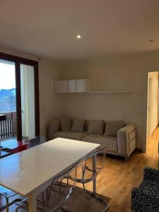 a living room with a couch and a table at Inserrata Abetone in Tuscany in Abetone +20 photos