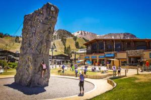a group of people playing on a rock wall at Chamonix 20 in Mammoth Lakes