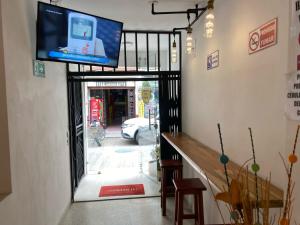a flat screen tv on the wall of a building at Hotel Don Pacho in Los Andes