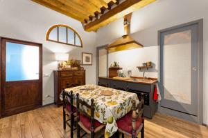 a kitchen with a table and a sink at Al Carmine Apartments Towers view with AC in Lucca