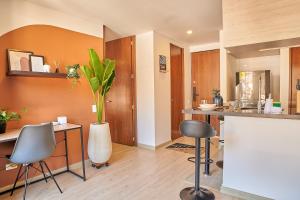 a kitchen with a counter with chairs and a vase at Bogotá Market & Finance Hub in Bogotá