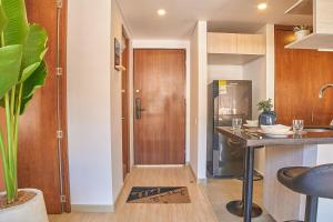 a kitchen with a table and a refrigerator at Bogotá Market & Finance Hub in Bogotá
