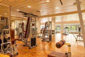 a gym with several treadmills and machines in it at Hotel Majesty Bari in Bari