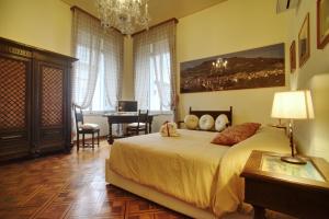 a bedroom with a large bed and a desk at Luxury B&B '700 in Ascoli Piceno