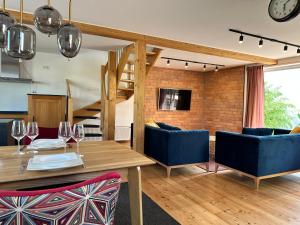 a dining room with a table and blue chairs at Ferienhaus Wein & Wald mit Gartensauna in Landau in der Pfalz