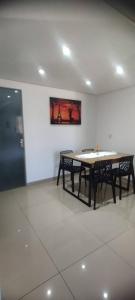 a dining room with a table and two benches at Apartamento Centro de Rio Grande in Rio Grande +24 photos