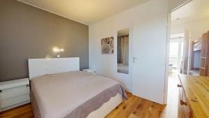 ein Schlafzimmer mit einem weißen Bett in einem Zimmer in der Unterkunft Le Reflet Marin in Les Bains + 25 Fotos