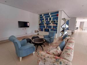 a living room with a couch and two chairs and a table at Villa Michel Lucas in Marrakesh