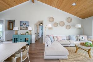 a living room with a couch and a table at One Particular Harbor - Harbor Island Oceanfront, Private Pool! in Cedar Reef Villas