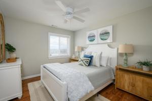 a bedroom with a white bed with a ceiling fan at One Particular Harbor - Harbor Island Oceanfront, Private Pool! in Cedar Reef Villas +77 photos